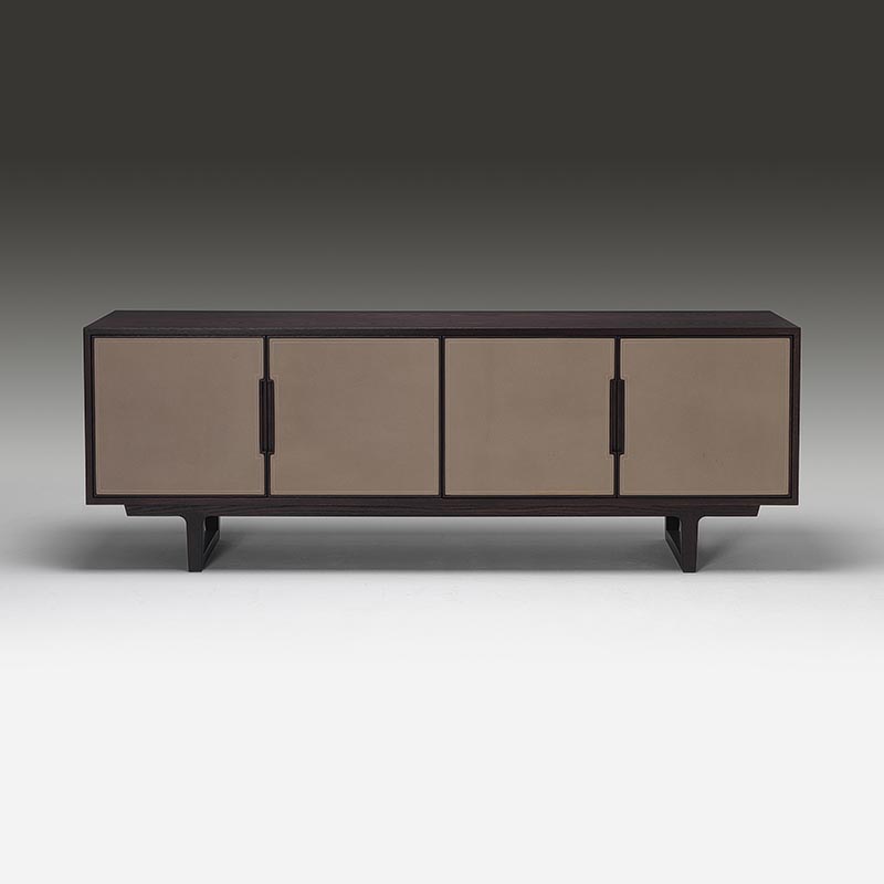 Front view of four-door oak sideboard with leather-wrapped panels and brass handles