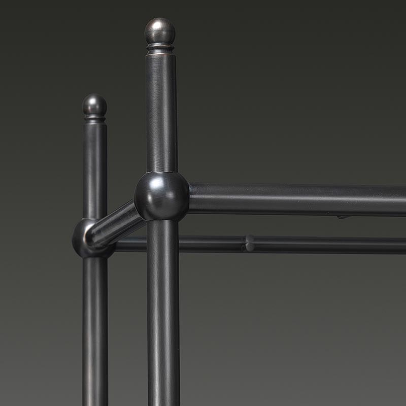 Close-up of black metal frame and joint detail on tiered shelving unit