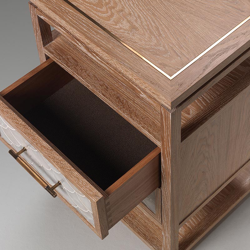 Close-up of oak nightstand drawer showing dovetail joinery and fish scale front