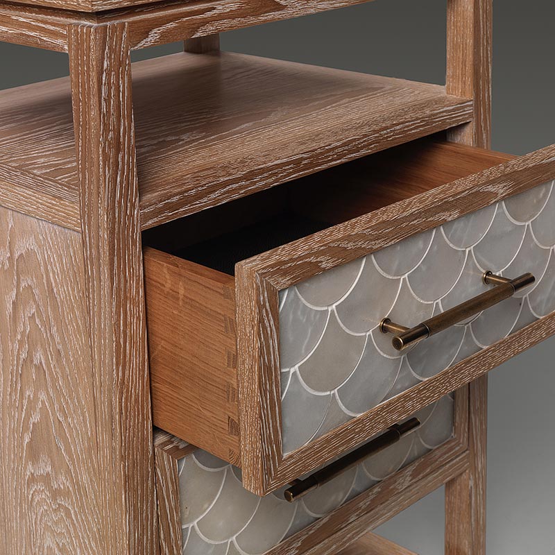 Detail of limed oak nightstand with open drawer and fish scale panel front